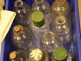 many empty bottles in a blue box on the floor