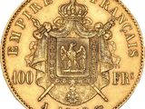 a close up of a gold coin with a coat of arms on it