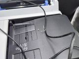 a black and white photo of a printer with wires attached to it