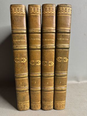 trois vieux livres posés sur une table l'un à côté de l'autre