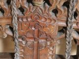 a close up of a wooden chair with a rope on it