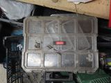 a small plastic box with a lot of tools inside of it