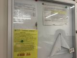 a picture of a bulletin board with a fire extinguisor attached to it