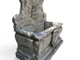 a stone bench with a bird sitting on top of it