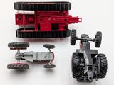 a red toy truck and a black toy car on a white surface