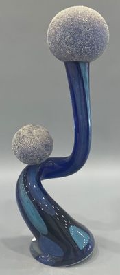 a blue vase with two rocks on top of it