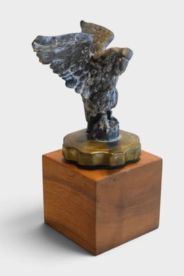 statue of an eagle on a wooden base on a white background