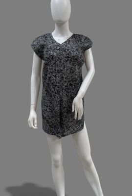 female mannequin in a black and white dress on a gray background