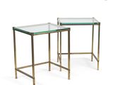 a pair of brass and glass side tables