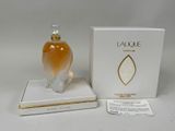 an image of a bottle of perfume sitting on top of a white box