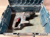 a drill in a tool box on a table