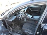 the interior of a car with the door open and the driver ' s seat down