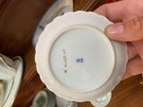a person holding a white plate with a blue design on it