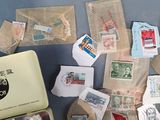 a suitcase full of stamps and envelopes on the floor