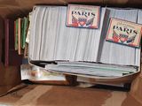a cardboard box filled with books and a bunch of papers