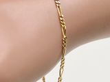 a close up of a hand with a gold bracelet on it
