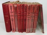 six red books sitting on top of each other on a white surface