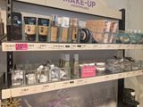 a lot of makeup products on the shelves in the store