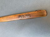 a baseball bat that is laying on a table