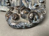 a close up of a stone sculpture of a bear