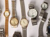 a lot of watches that are sitting on a table