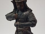 a statue of a man in armor holding a sword
