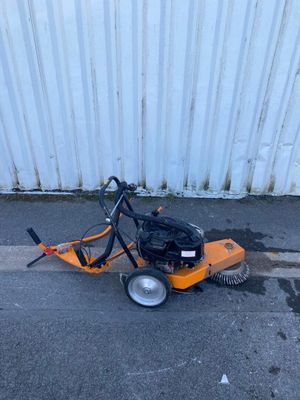 an image of a street sweeper on the side of the road