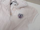 a white polo shirt with a tiger patch on it