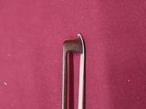 a pair of tongs sitting on top of a red surface