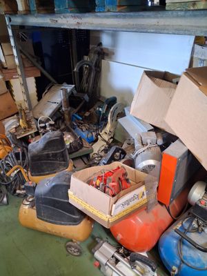 a pile of assorted items on the floor of a garage