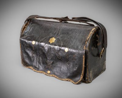 an old black leather bag with a gold star on it