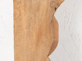 a piece of wood hanging from a hook on a wall