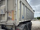 une photo d'un camion-benne garé sur un parking