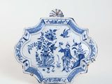 blue and white plate with a bird and flowers design on it