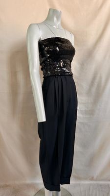 the mannequin is wearing a black and silver top and black pants