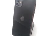 a black iphone sitting on a stand on a white surface