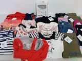 a lot of clothes that are sitting on a table