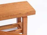 a wooden bench with a shelf on top of it