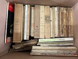 a box full of old books sitting on the floor