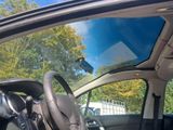 a view of the inside of a car from the driver ' s seat