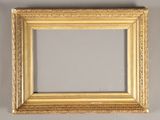 a gold framed mirror on a wall with a white background