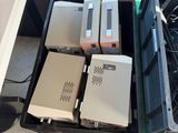 a lot of electronic equipment in a box on the floor
