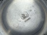 a silver plate that has a picture of a dog on it