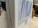 a computer monitor sitting on top of a cardboard box