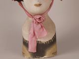 a mannequin head wearing a pink hat and a pink scarf