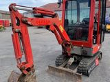 an image of a small red excavator parked in a lot