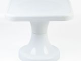 a white cake stand with a white base on a white background