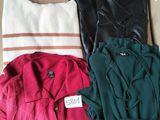 three pairs of shirts in a box on a couch