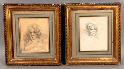 two framed drawings of a woman ' s face and a man ' s head