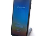 an image of a cell phone with a welcome screen on a stand